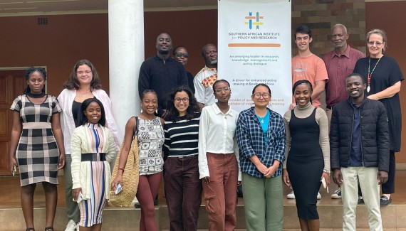 A group of study abroad students pose for a photo at the Southern African Institute for Policy and Research.